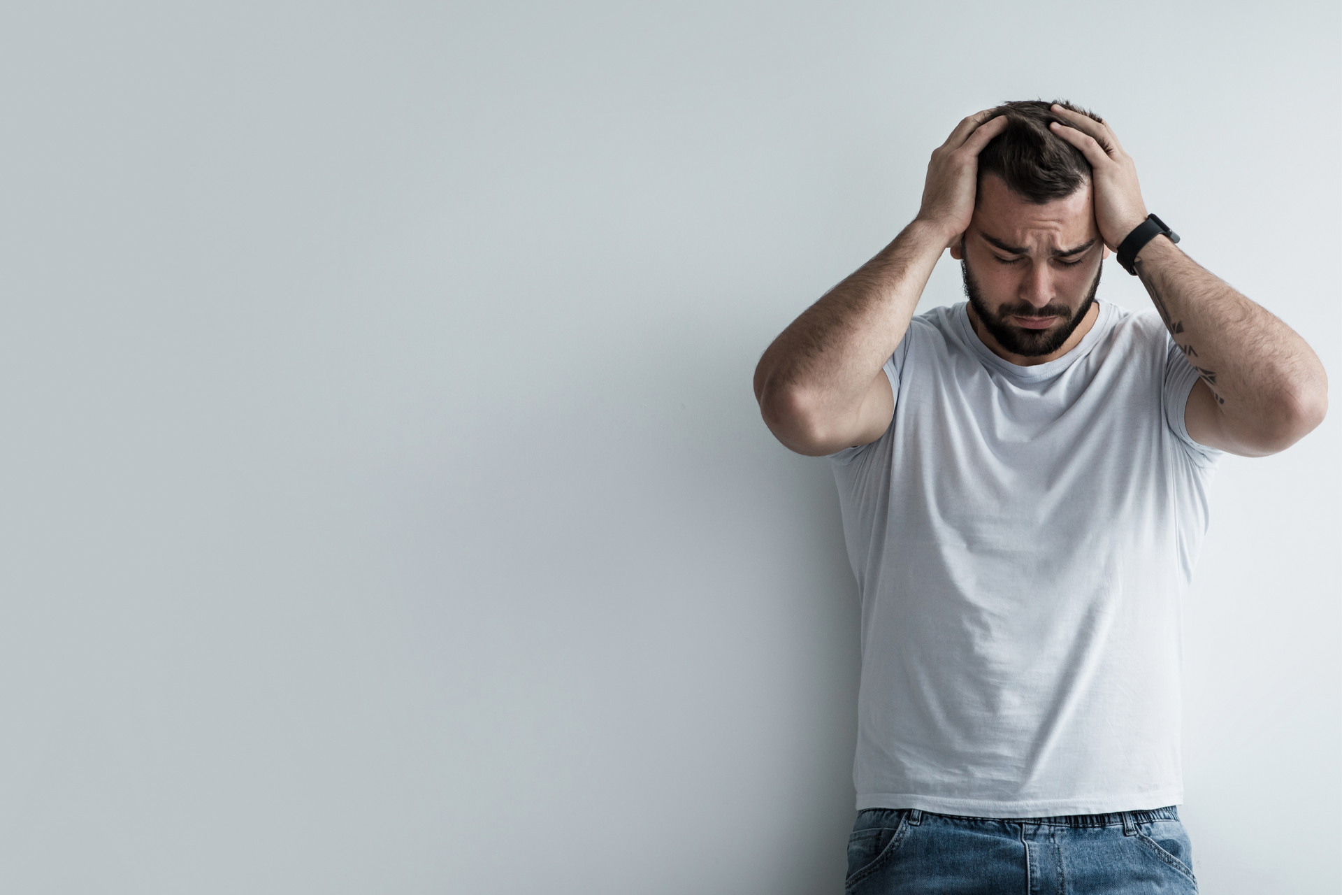 Person holding their head with a distressed expression, experiencing a PTSD flashback