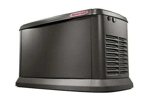 A black generator is sitting on top of a white surface.