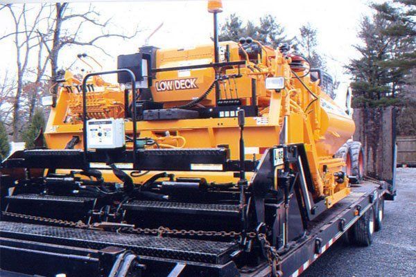 A yellow truck with the word low deck on it