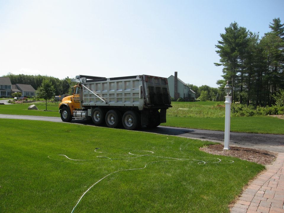 A dump truck is parked on the side of the road