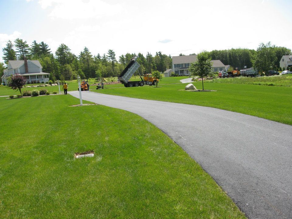 A dump truck is sitting on the side of a road