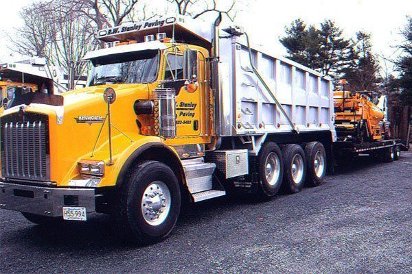 A kenworth dump truck is parked on the side of the road
