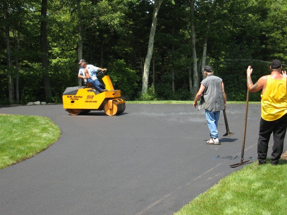 A man is riding a yellow roller on a road