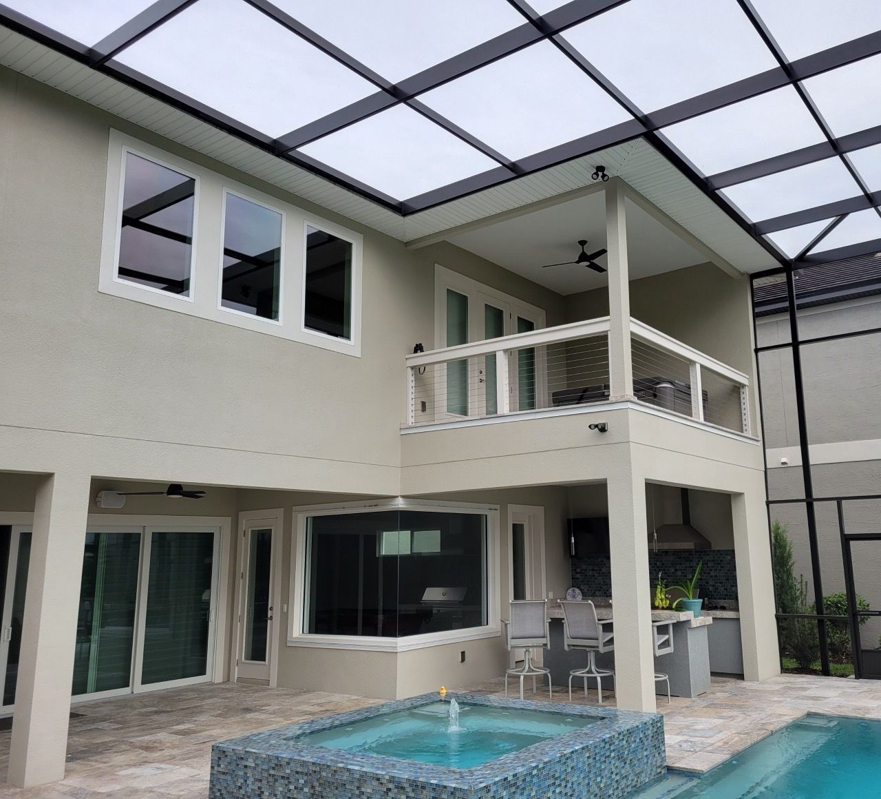 A large house with a swimming pool in front of it