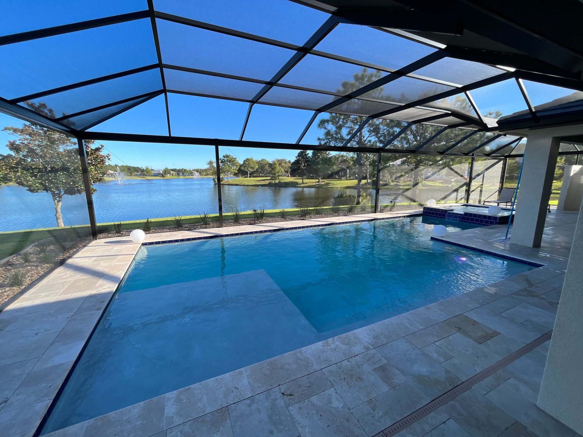 A large swimming pool with a view of a lake