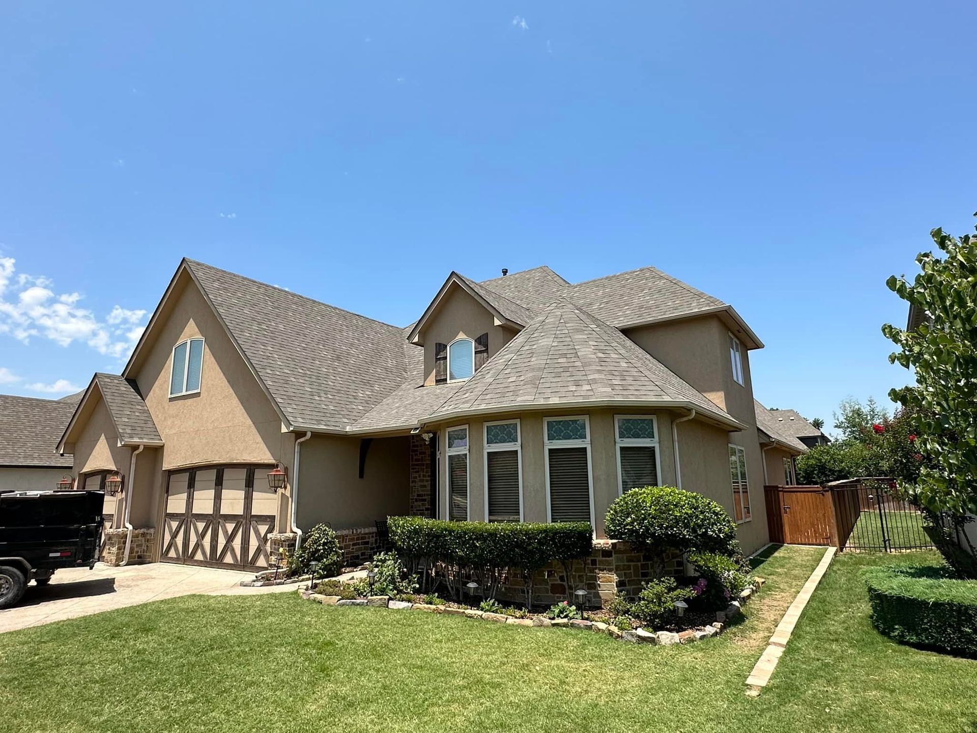 A large house with a large lawn in front of it.