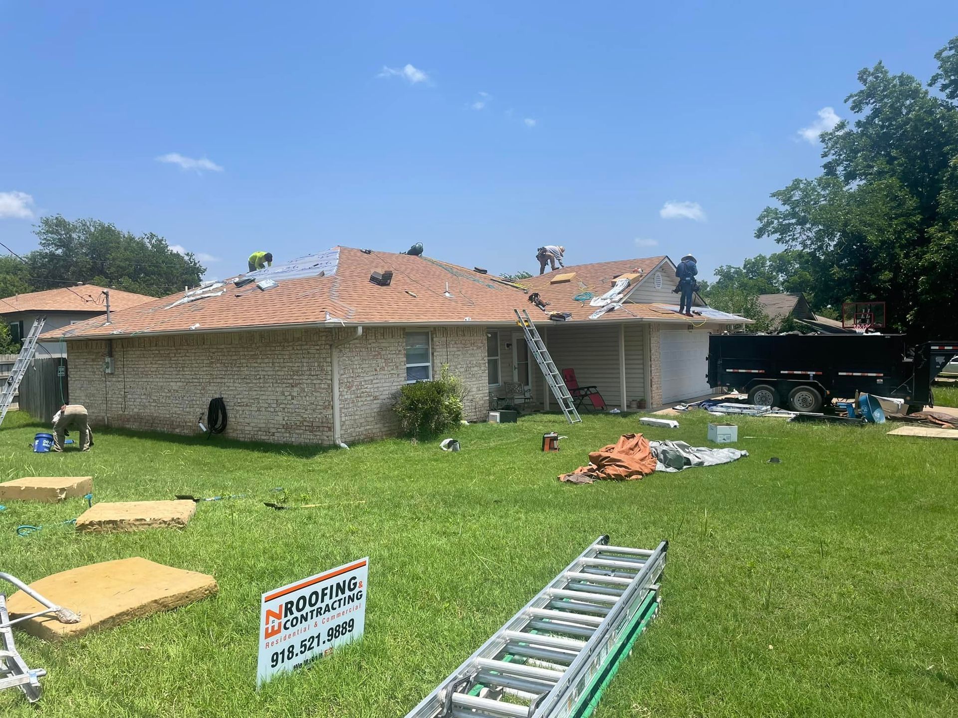 A house is being remodeled with a roof being installed.