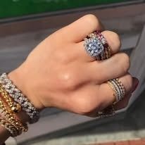 Hand with diamond rings and bracelets.