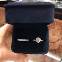 Close-up of a blue ring box open, displaying two diamond rings.