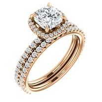 Rose gold engagement ring with a cushion-cut diamond and a double diamond band.