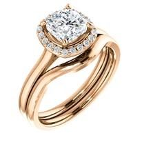 Rose gold engagement ring with a cushion-cut diamond and halo, and a matching band.
