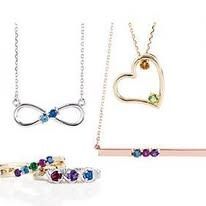 Jewelry set: necklaces with gemstone pendants, and rings with colorful stones.
