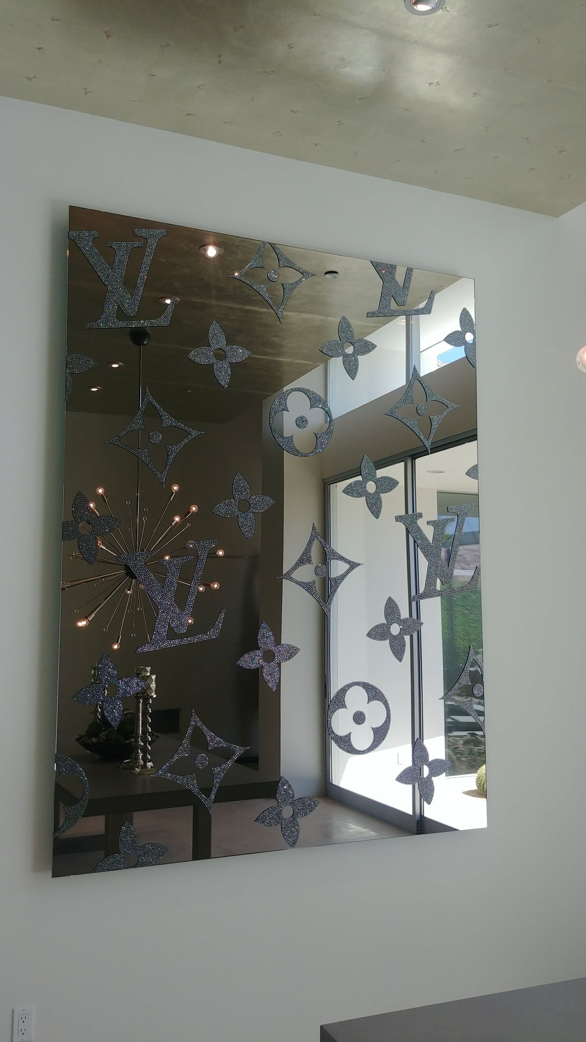 A large mirror with louis vuitton logos on it
