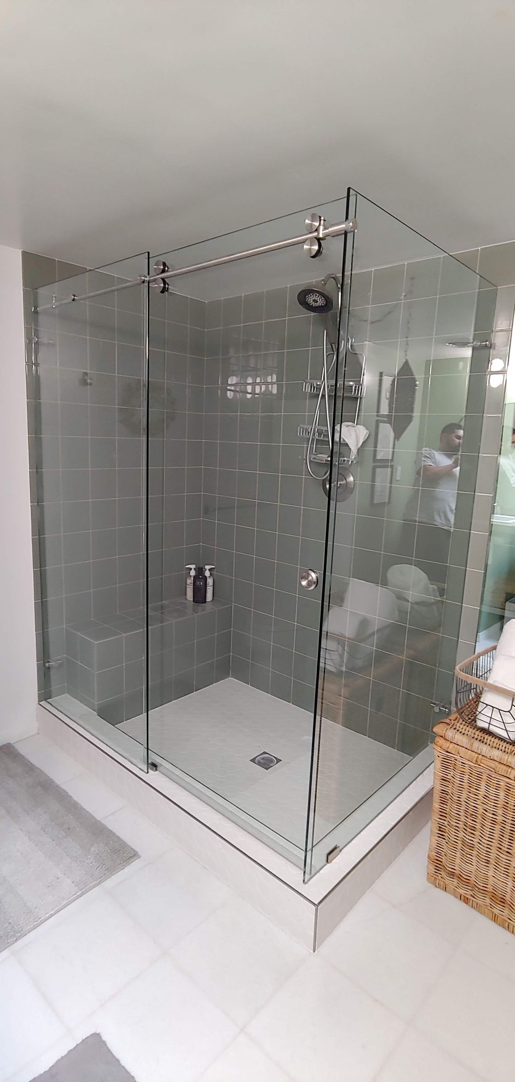 A bathroom with a walk in shower and a sink.