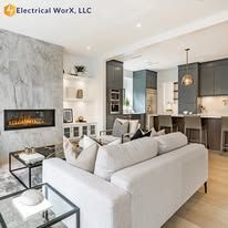 A living room with a white couch and a fireplace.