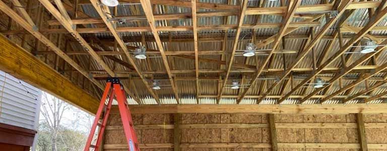 A ladder is sitting in the middle of a wooden structure.