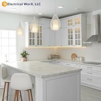 A kitchen with white cabinets , granite counter tops , and stainless steel appliances.