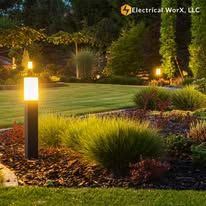 A garden with a lamp post in the middle of it.