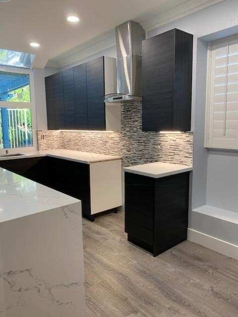 white marble countertop with black cabinets