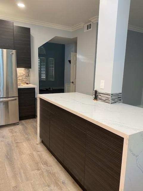 white countertop with stainless fridge
