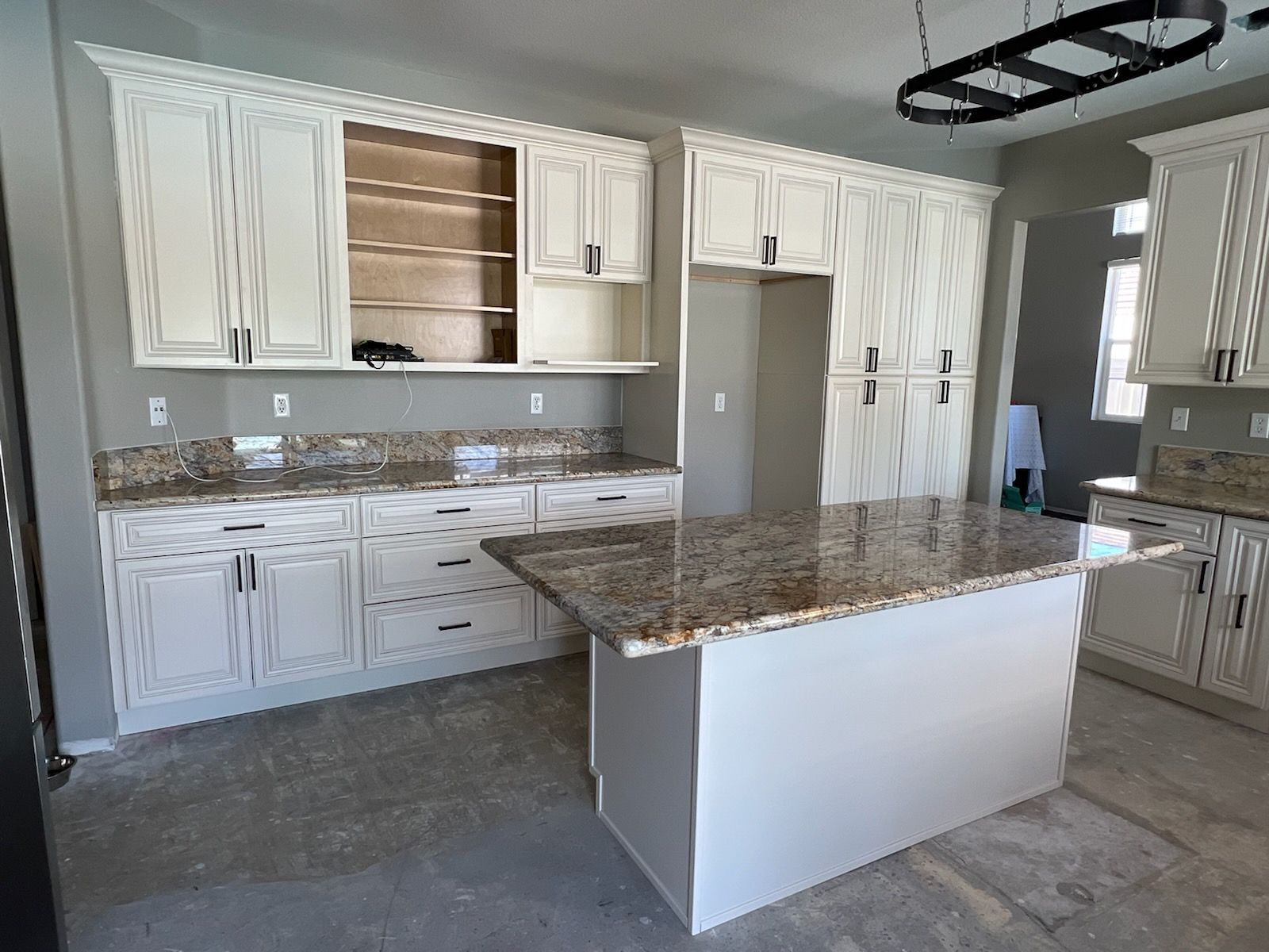 kitchen with white cabinets and marble counter top