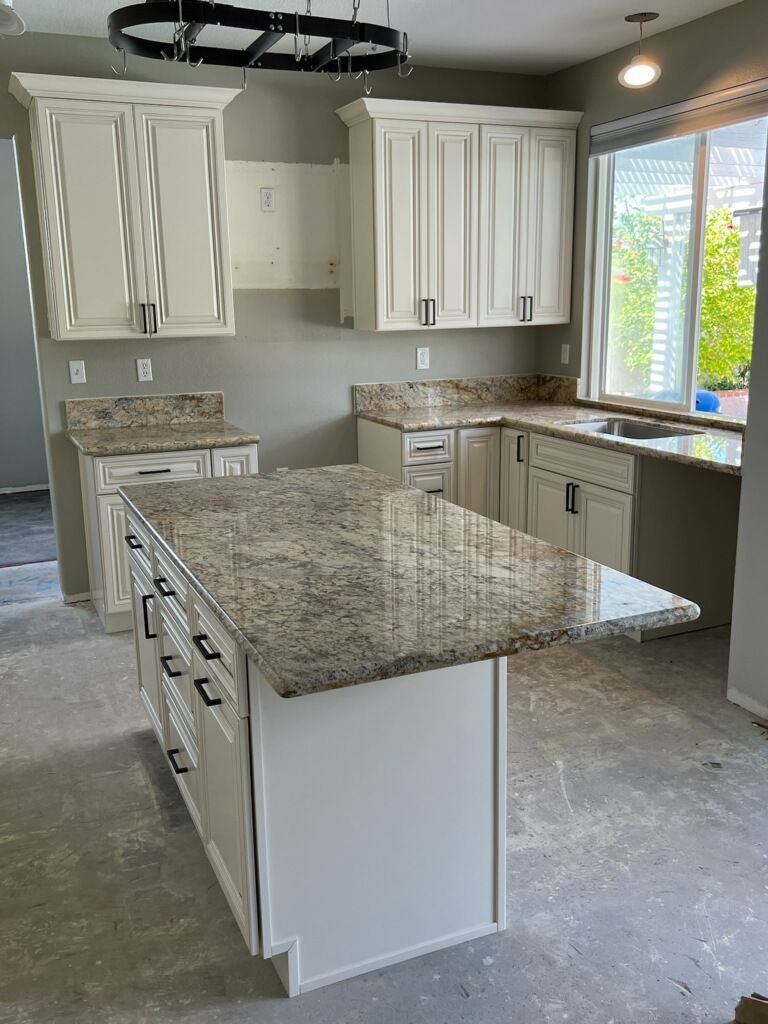kitchen with white cabinets and marble counter top