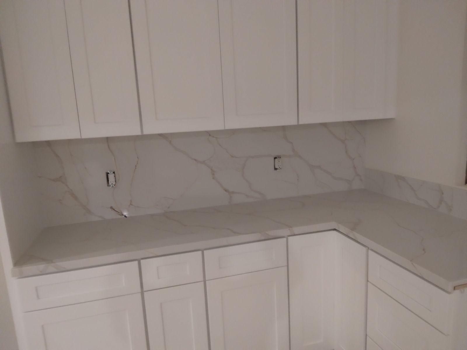 kitchen with white cabinets and white marble counter top