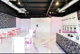 A restaurant with tables and chairs and a counter.