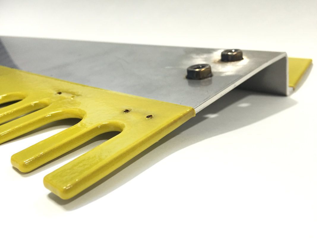 A pair of scissors with yellow handles on a white surface