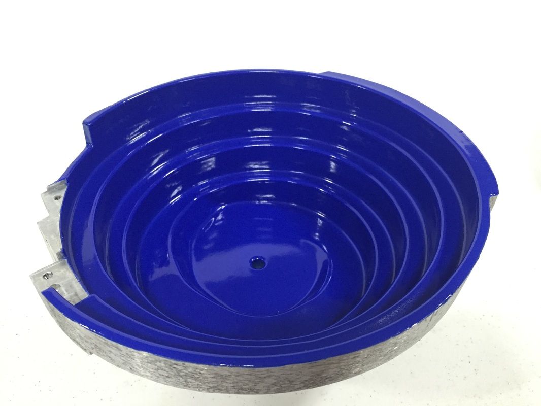 A blue bowl is sitting on a white surface