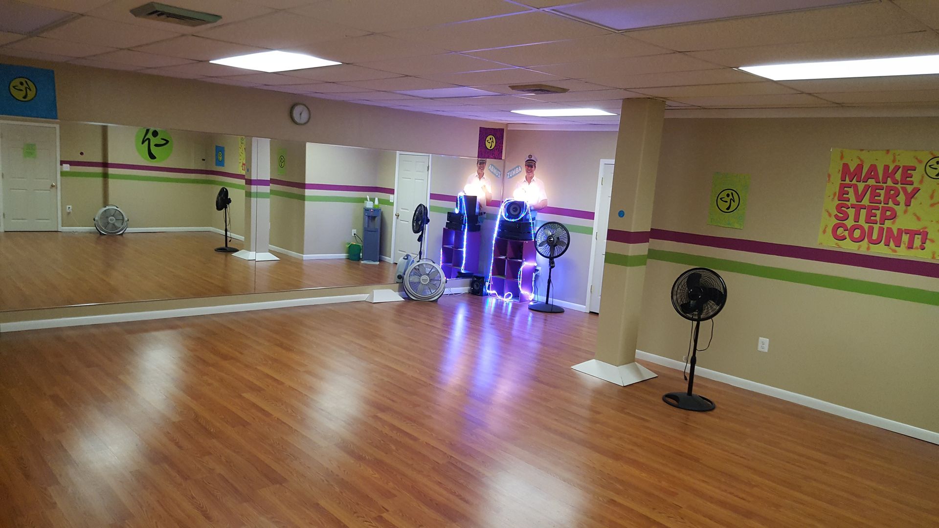 An empty dance studio with a sign.