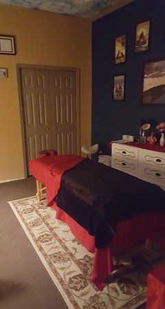 There is a massage table in the middle of the room.