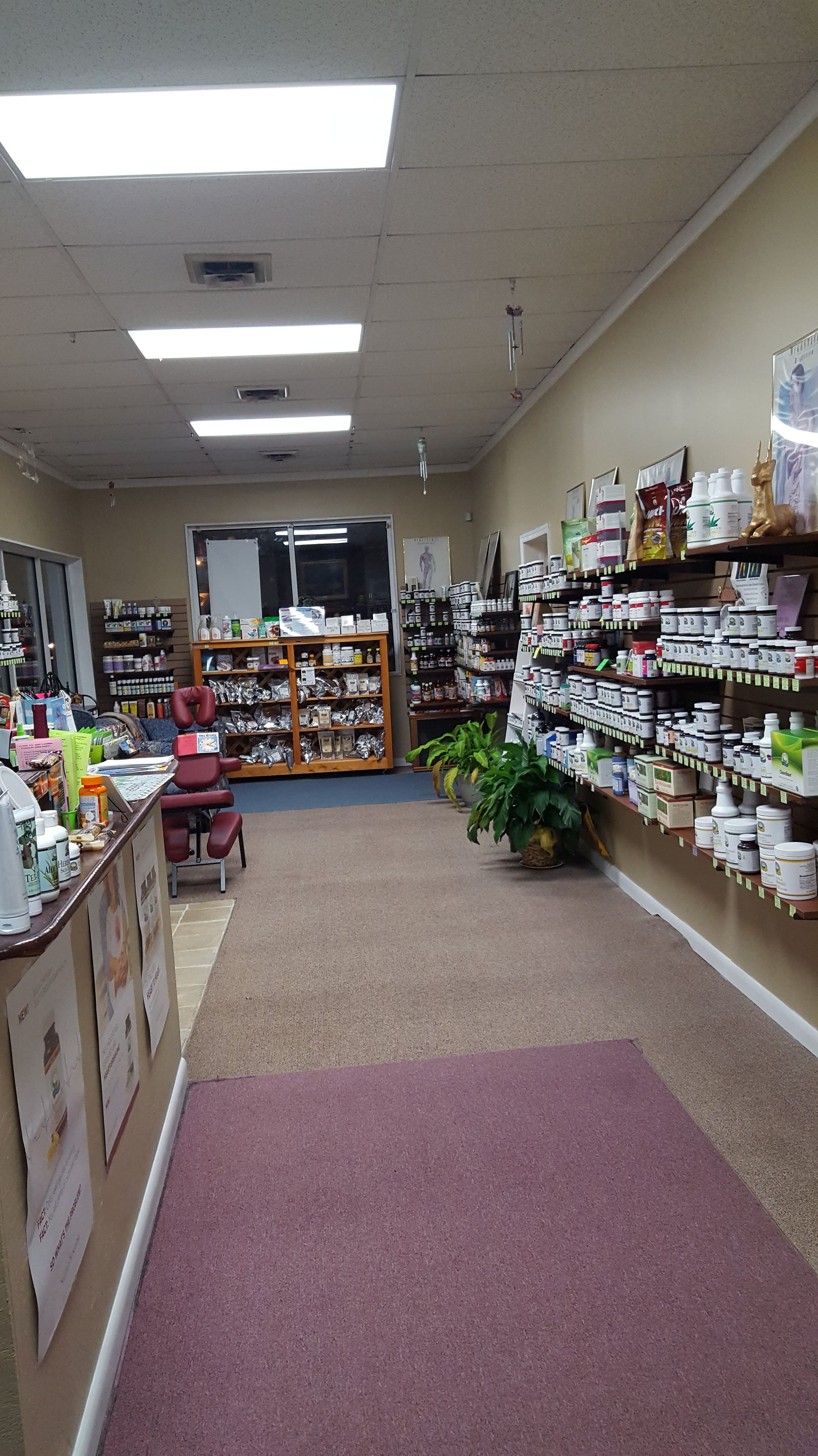 A long hallway in a store filled with lots of products.