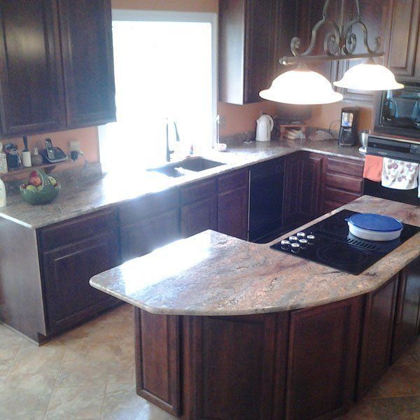 A kitchen with wooden cabinets and granite counter tops