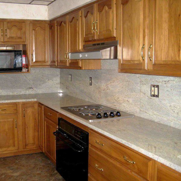 A kitchen with wooden cabinets and granite counter tops