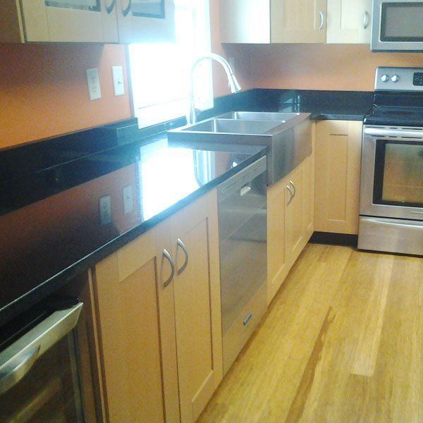 A kitchen with stainless steel appliances and wooden cabinets