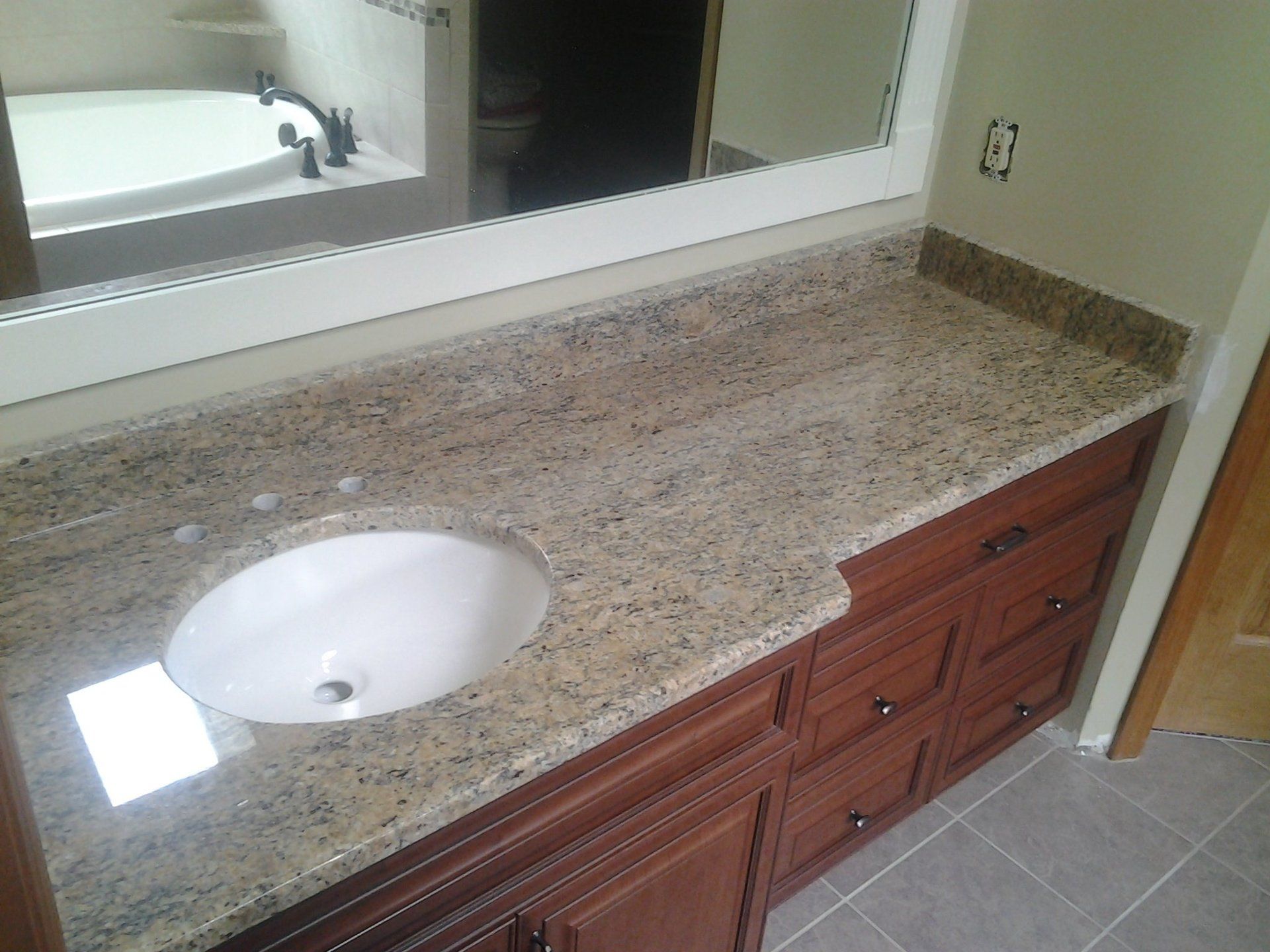 A bathroom vanity with a sink and a mirror