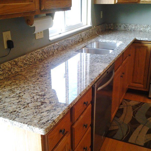 A kitchen with granite counter tops and stainless steel appliances