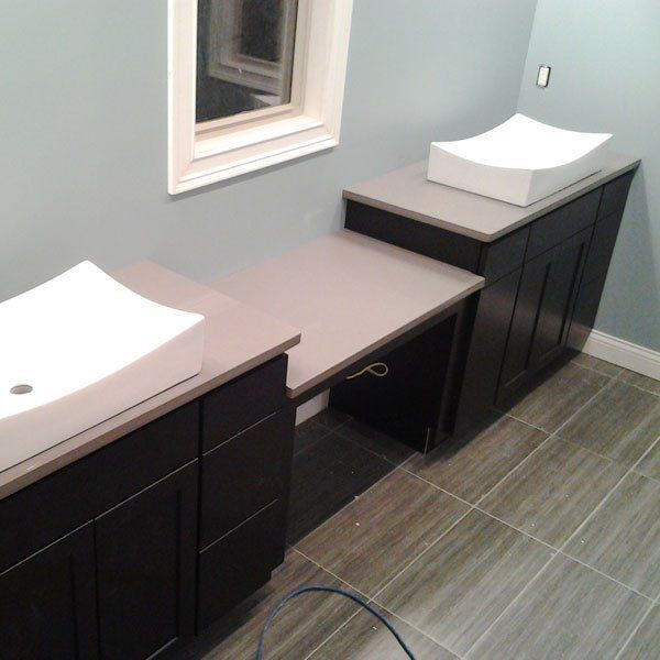 A bathroom with two sinks and a window