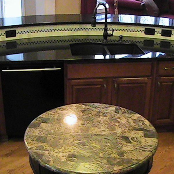 A kitchen with a round table and a sink