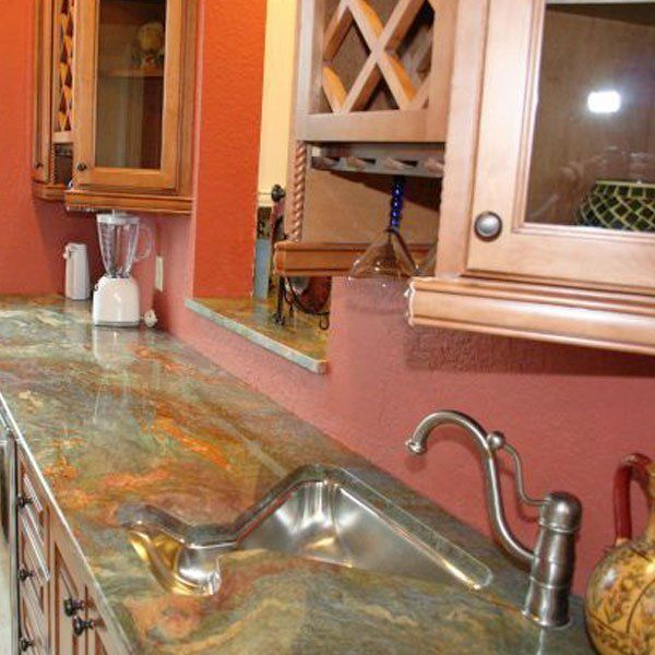 A kitchen counter with a sink and a blender