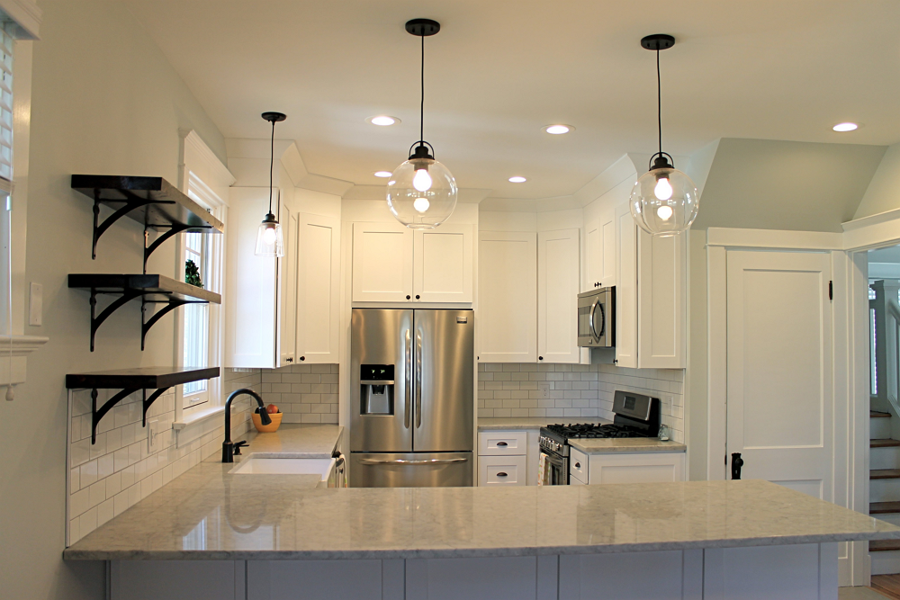 A kitchen with white cabinets and stainless steel appliances.