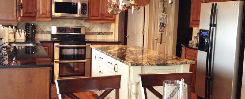 A kitchen with a table and chairs and a refrigerator.