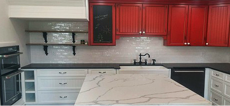 A kitchen with red cabinets and a white counter top