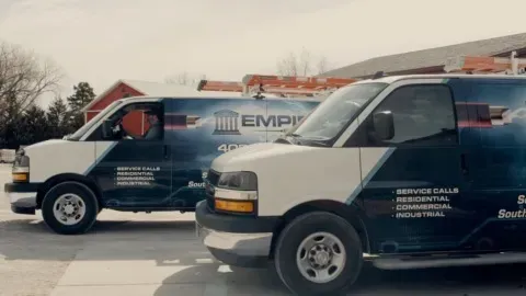 Two vans are parked next to each other and one has the word empire on it