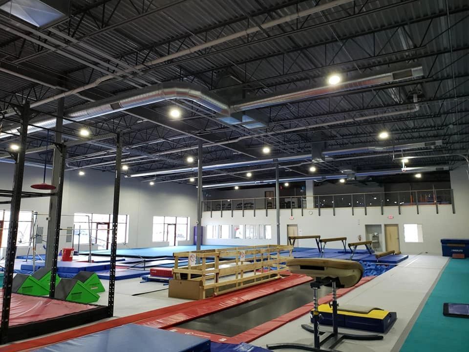 A gym filled with trampolines and a basketball hoop