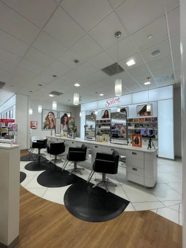 A hair salon with a lot of chairs and tables