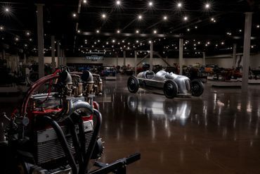 A warehouse filled with lots of old cars and engines.