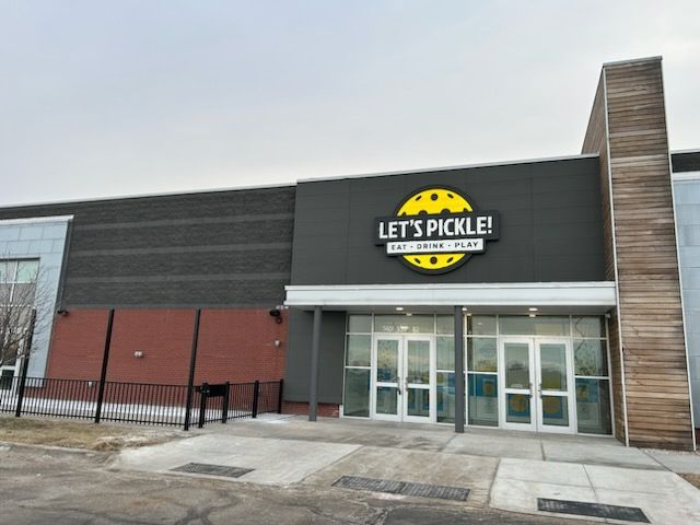 A building with a sign that says let 's pickle