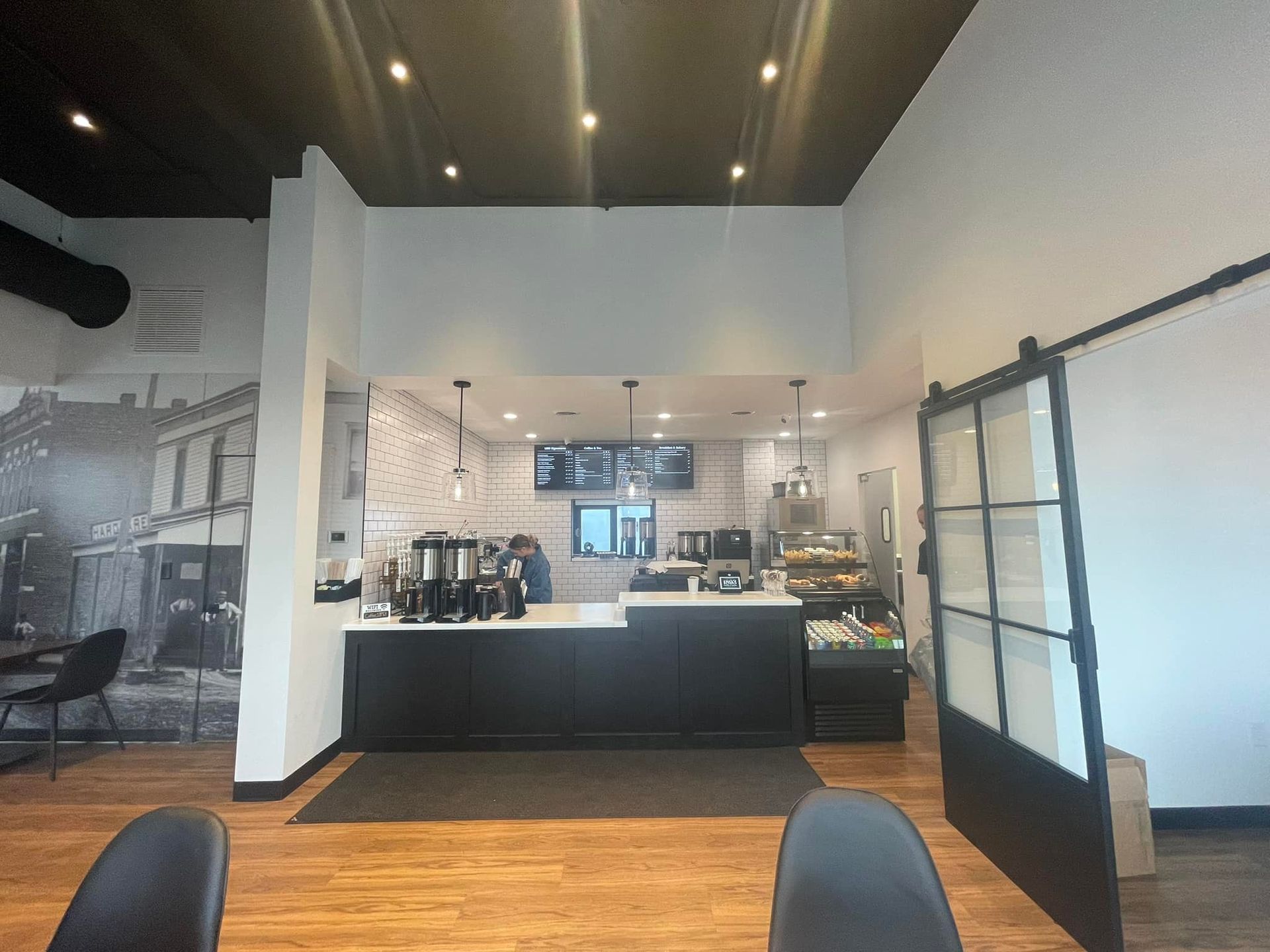 The inside of a restaurant with a sliding glass door and a counter.